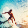 Surfer on Blue Ocean Wave Getting Barreled at Sunrise / Sport
