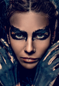 conceptual close up portrait of beautiful fashion look woman dark make up with gold