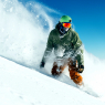 male snowboarder curved and brakes spraying loose deep snow on / Sport