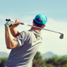 Golfer hitting golf shot with club on course while on summer v / Sport